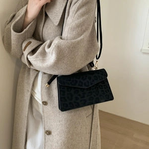 Elegant leopard print crossbody bag featuring a flat envelope flap and golden metal hooks