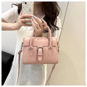 Mirror selfie showing the dusty pink matte leather shoulder bag with silver buckle