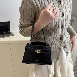 Elegant black crocodile pattern handbag with gold clasp lock and minimalist handle