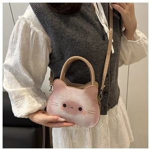 Pink and white gradient cat-shaped handbag with adjustable strap shown on model