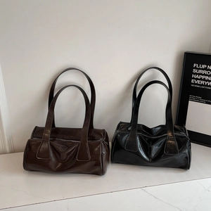 Minimalist glossy faux leather pillow bag for women in dark brown and black colors