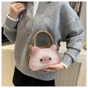 Detail view of pink cartoon cat toast bag with adjustable shoulder strap on a model