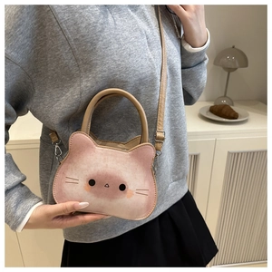 Macro shot showing the pink cat shape design and stitching on the faux leather bag