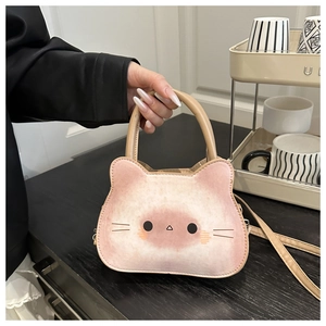 Detailed view of the cute cat face design on the pink PU leather shoulder bag