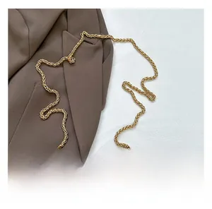 Close-up of golden braided chain strap on corduroy bucket bag with rich texture details