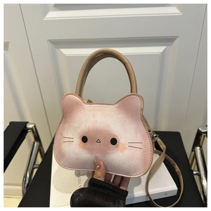 Detail of pink cat-shaped toast bag showing soft texture and adjustable shoulder strap