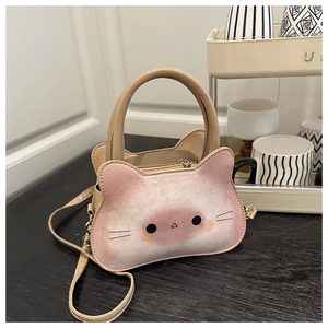 Detail of cute cat-shaped crossbody bag with beige leather and kitten face design