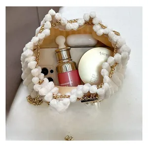 Detail view of large capacity plush bucket bag holding phone and cosmetics