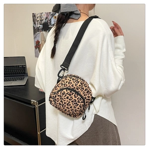 Detail view of lightweight leopard print crossbody bag with adjustable wide strap
