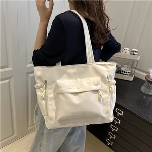 White large capacity nylon tote bag with side zipper pockets for casual commuting style