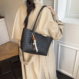 Fashionable black woven leather tote bag with colorful wooden bead charm for daily commute