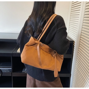 Detail of vintage matte suede tote bag with long shoulder strap and adjustable side buckle