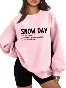 Close-up of pink oversized sweatshirt featuring snow day dictionary definition print