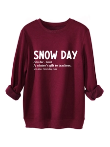 Detail of burgundy snow day sweatshirt showing plush fabric texture and white text print