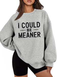 Close-up of grey sweatshirt fabric and bold I COULD BE MEANER lettering details