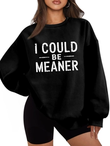 Detail of the distressed white lettering print on a black oversized crewneck sweatshirt