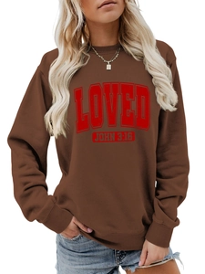 Detail of rib-knit cuffs and hem on a brown crewneck sweatshirt with red Loved print