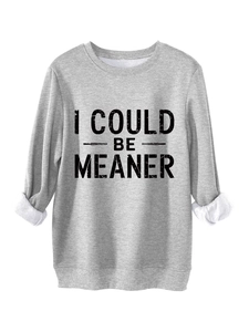 Detail of grey oversized sweatshirt showing 'I COULD BE MEANER' black letter print