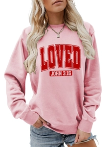 Close-up of pink crewneck sweatshirt featuring red vintage LOVED JOHN 3:16 print texture