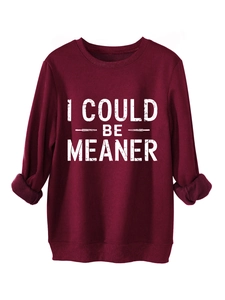 Detail of burgundy fleece sweatshirt featuring white I COULD BE MEANER letter print