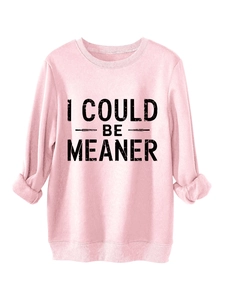 Close-up of pink oversized sweatshirt showing black I COULD BE MEANER vintage print detail