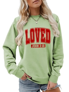 Detail of light green sweatshirt featuring red LOVED JOHN 3:16 text and ribbed cuffs