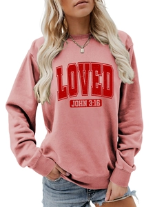 Close-up of coral pink sweatshirt featuring red Loved John 3:16 text and ribbed collar