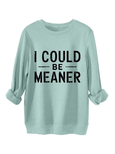 Detail of mint green sweatshirt with I COULD BE MEANER print and ribbed cuffs