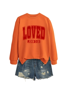 Detail of orange crewneck sweatshirt with LOVED print and ripped denim shorts set
