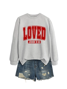 Detailed look at the grey crewneck sweatshirt with red LOVED print and denim shorts