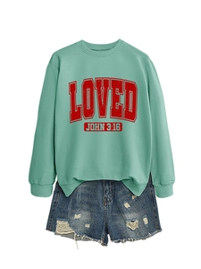 Detail of mint green crewneck sweatshirt featuring red vintage LOVED graphic print