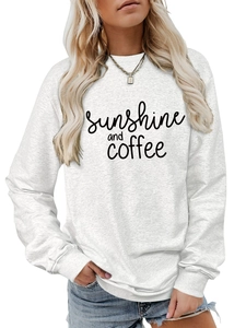 Detail of sunshine and coffee print on white long sleeve crewneck cotton sweatshirt