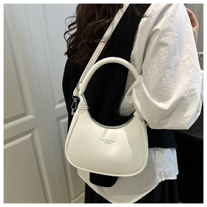 Detail view of white crescent bag with FASHION & BAGS LEATHER print and top handle