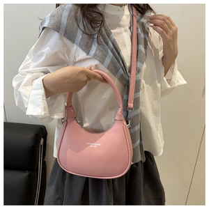 Detail view of pink leather half-moon bag featuring elegant logo and metal zipper