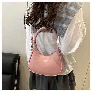 Detail of pink crescent moon bag featuring fashion leather print and adjustable strap