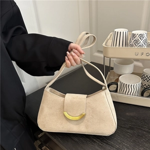 Beige suede hobo bag with gold hardware and double straps for elegant shoulder carry