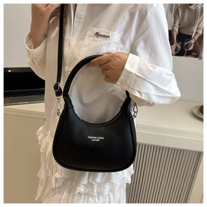 Detail of black crescent hobo bag featuring silver hardware and a removable shoulder strap