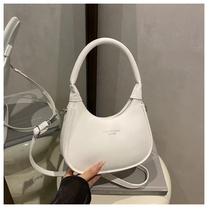 Macro view of white leather hobo bag with zip closure and silver metal hardware details