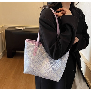 Detail view of purple ethnic tote bag with geometric floral patterns and metal rivets