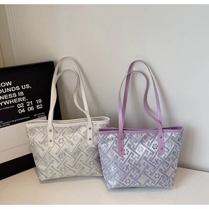 Detail of geometric floral jacquard pattern on silver and purple tote bags for women