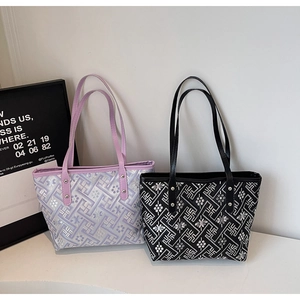 Detail view of plaid tote bags in purple and black with vintage floral patterns and rivets