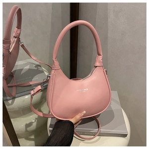 Detail of pink crescent bag with silver fashion text, round handle and adjustable strap