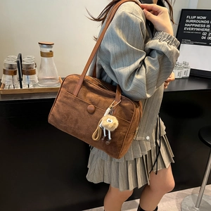 Retro brown suede underarm tote bag with plush pendant and round buckle detail