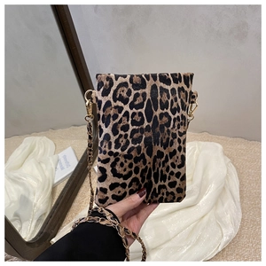 Detail of leopard print mini bag with gold chain strap and textured faux fur finish