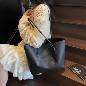 Large black leather tote bag with embossed letters for women, casual commuting style