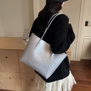 Large silver tote bag with embossed lettering for women's daily commute and travel