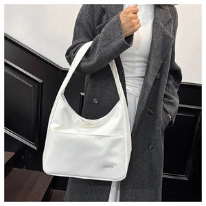 Minimalist white PU leather tote bag with FASHION lettering styled with wool coat