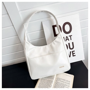 Detail of white minimalist faux leather tote bag with gold fashion typography