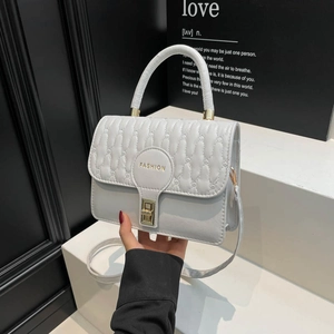 Quilted light blue leather small square handbag with golden clasp and top handle