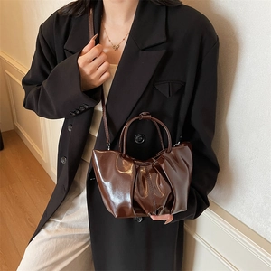 Chic dark brown pleated cloud bag with glossy finish and versatile crossbody strap